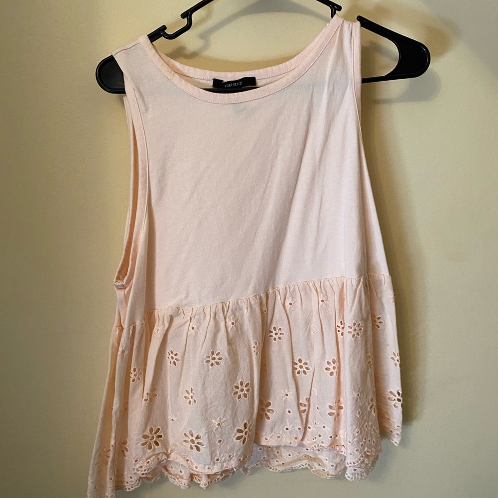 Light pink peplum top with laser cut bottom detail